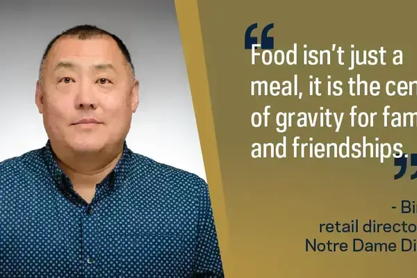 Bin An, retail director for Notre Dame Dining, an East Asian man in a blue patterned shirt.